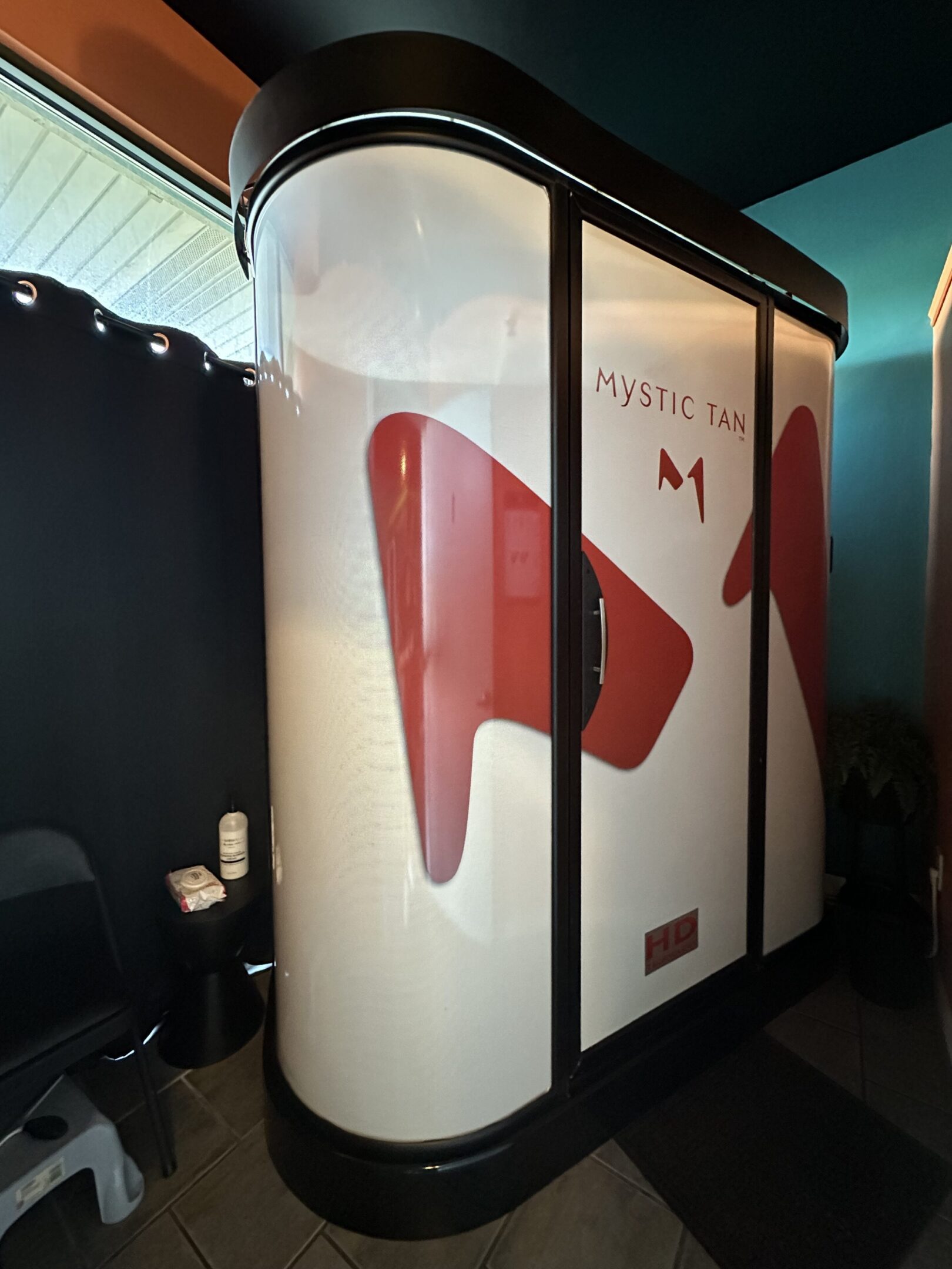 Modern airplane lavatory door with a red design and signage.
