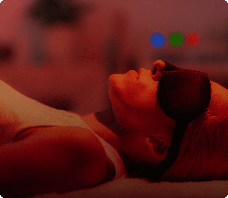 Person relaxing with eye mask on.