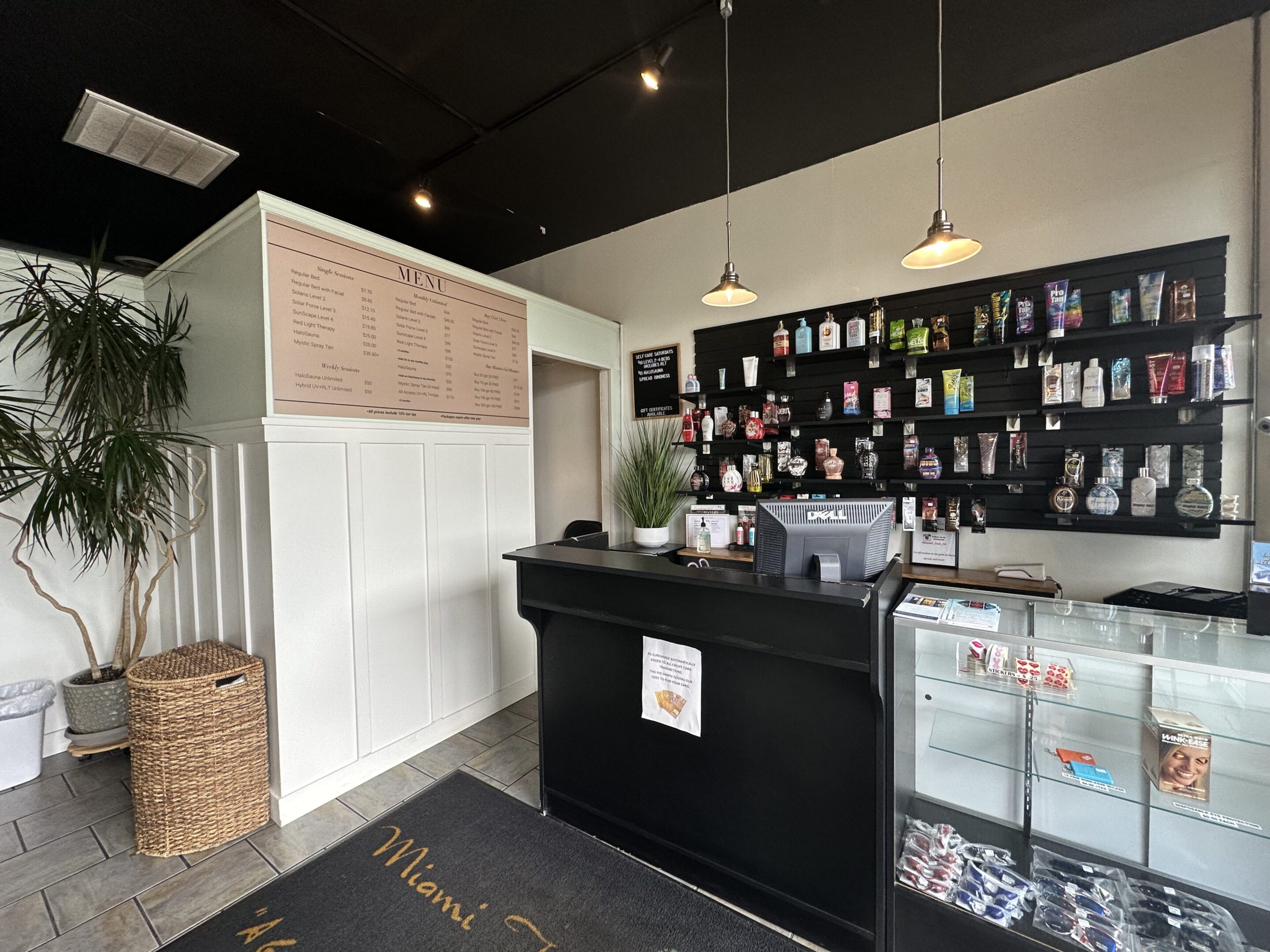 Modern cafe counter with menu and display case.